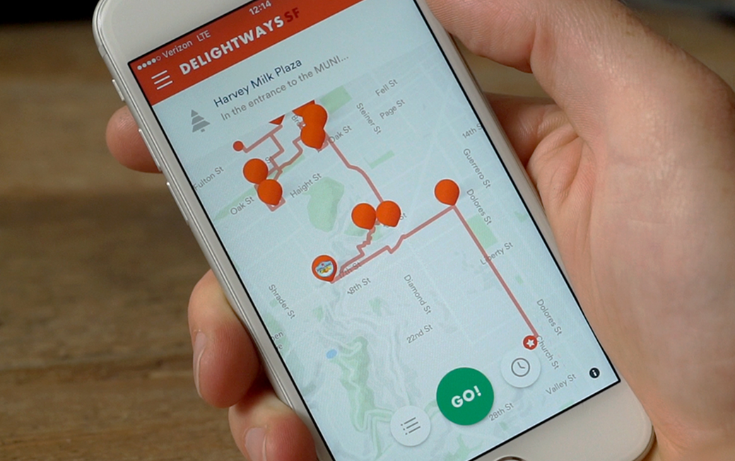 Close-up photography of a hand holding a phone with the Delightways app featured