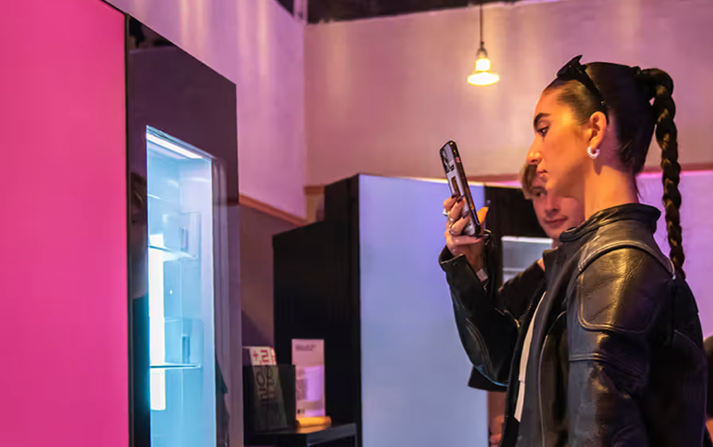 Photo of woman taking a photo of an LG MoodUp refrigerator 